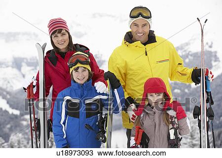 Stock Image - Family On Ski Holiday In Mountains. Fotosearch