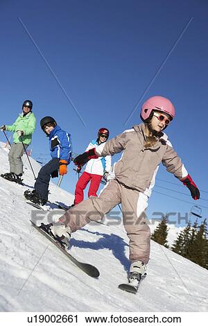 Stock Image - Family On Ski Holiday In Mountains. Fotosearch