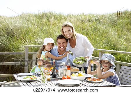 Family on vacation eating outdoors View Large Photo Image Picture - Family on vacation eating outdoors. Fotosearch