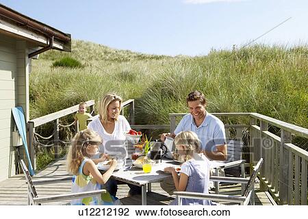 Family on vacation eating outdoors View Large Photo Image Stock Image - Family on vacation eating outdoors. Fotosearch
