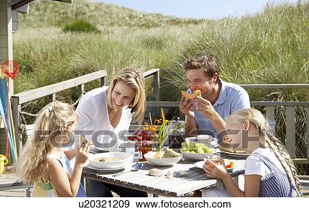 Family on vacation eating outdoors View Large Photo Image Stock Photo - Family on vacation eating outdoors. Fotosearch