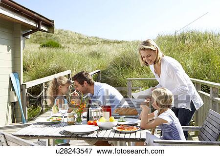 Stock Photo - Family on vacation eating outdoors. Fotosearch