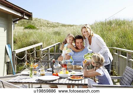 Family on vacation eating outdoors View Large Photo Image Stock Photograph - Family on vacation eating outdoors. Fotosearch
