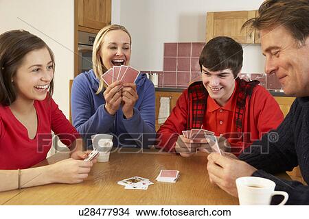 Picture - Family Playing Cards In Kitchen. Fotosearch