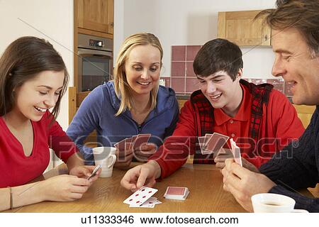 Stock Photograph - Family Playing Cards In Kitchen. Fotosearch