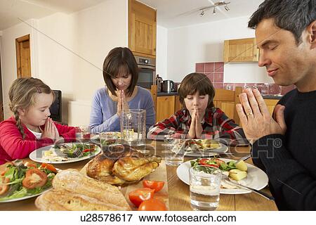 Family Saying Grace Before Eating Lunch Together In Kitchen View Large Photo Image Stock Photo - Family Saying Grace Before Eating Lunch Together In Kitchen. Fotosearch