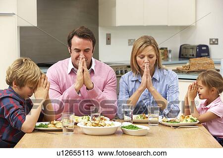 Family saying grace before meal View Large Photo Image Stock Image - Family saying grace before meal. Fotosearch