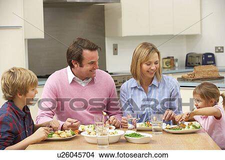 Picture - Family sharing meal together at home. Fotosearch