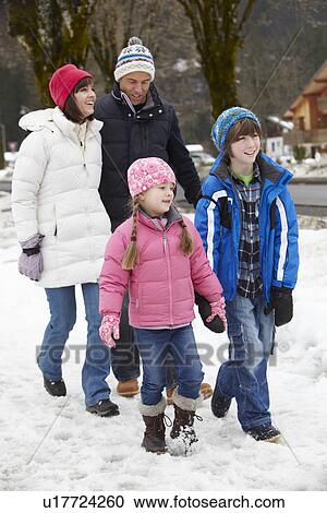 Family Walking Along Snowy Street In Ski Resort View Large Photo Image Stock Image - Family Walking Along Snowy Street In Ski Resort. Fotosearch
