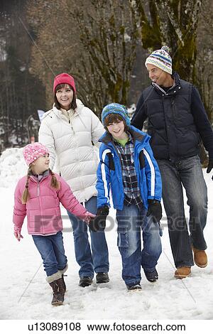 Family Walking Along Snowy Street In Ski Resort View Large Photo Image Stock Photo - Family Walking Along Snowy Street In Ski Resort. Fotosearch