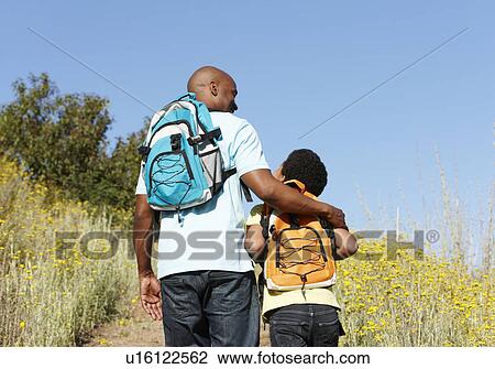 Stock Image - Father and son on country hike. Fotosearch