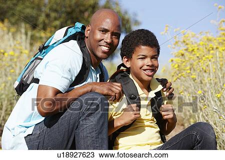 Stock Image - Father and son on country hike. Fotosearch