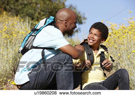 Stock Photo - Father and son on country hike. Fotosearch