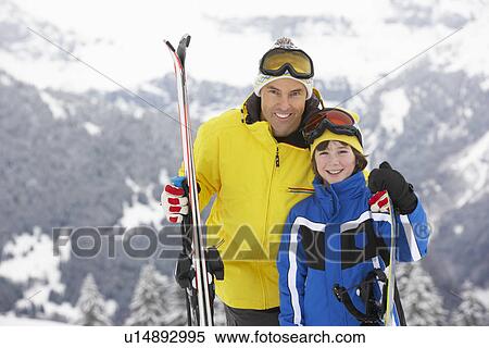 Stock Photography - Father And Son On Ski Holiday In Mountains. Fotosearch