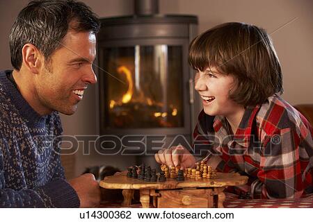 Father And Son Playing Chess By Cosy Log Fire View Large Photo Image Stock Image - Father And Son Playing Chess By Cosy Log Fire. Fotosearch