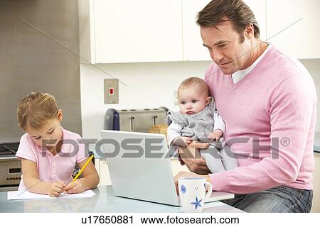 Father with children using laptop in kitchen View Large Photo Image Stock Image - Father with children using laptop in kitchen. Fotosearch