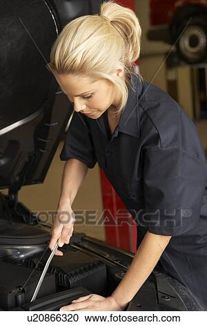 Stock Image - Female mechanic at work. Fotosearch