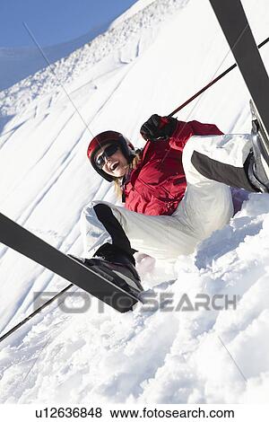 Stock Photo - Female Skier Sitting In Snow With After Fall. Fotosearch