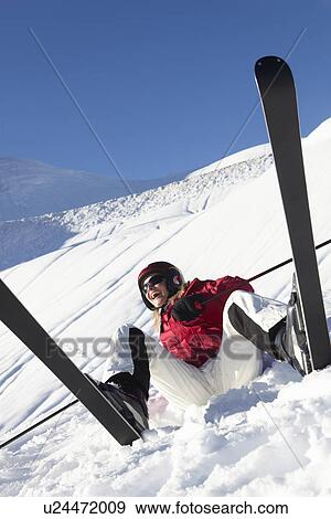 Stock Photo - Female Skier Sitting In Snow With After Fall. Fotosearch