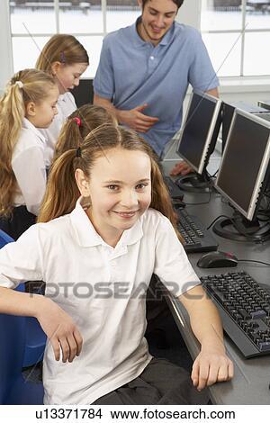 Picture - Girl in school class smiling to camera. Fotosearch