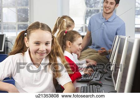 Stock Photo - Girl in school class smiling to camera. Fotosearch