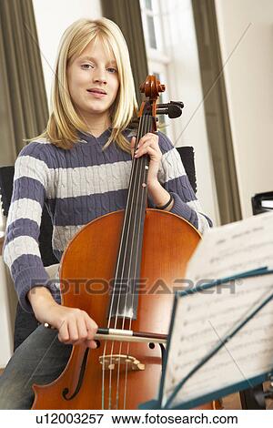 Girl playing cello at home View Large Photo Image Stock Photo - Girl playing cello at home. Fotosearch
