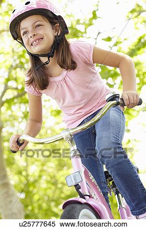 Girl riding bike View Large Photo Image Stock Photography - Girl riding bike. Fotosearch