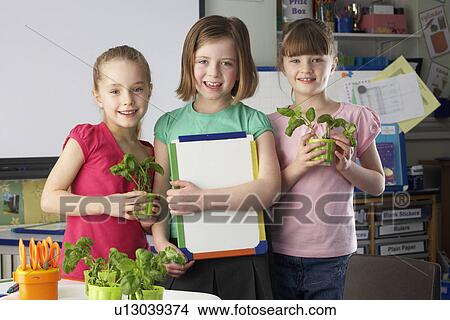Girls learning about plants in school class View Large Photo Image Picture - Girls learning about plants in school class. Fotosearch