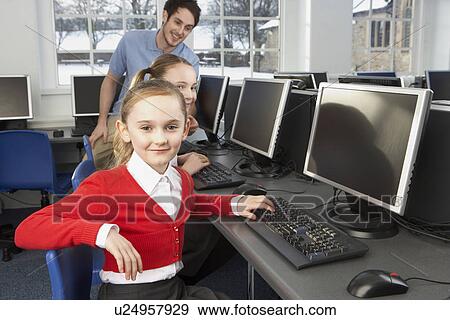 Stock Photo - Girls using computers in school class. Fotosearch