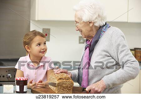 Grandmother and granddaughter preparing food in kitchen View Large Photo Image Stock Photo - Grandmother and granddaughter preparing food in kitchen. Fotosearch