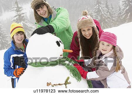 Group Of Children Building Snowman On Ski Holiday In Mountains View Large Photo Image Stock Image - Group Of Children Building Snowman On Ski Holiday In Mountains. Fotosearch