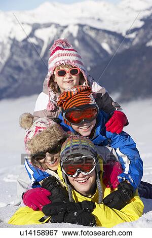 Stock Photo - Group Of Children Having Fun On Ski Holiday In Mountains. Fotosearch