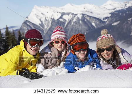 Stock Photo - Group Of Children Having Fun On Ski Holiday In Mountains. Fotosearch