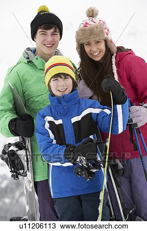 Stock Image - Group Of Children On Ski Holiday In Mountains. Fotosearch
