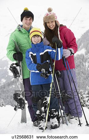 Stock Image - Group Of Children On Ski Holiday In Mountains. Fotosearch