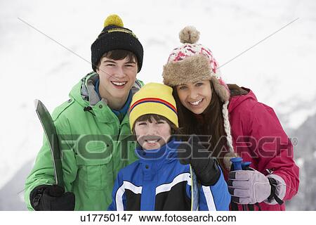 Stock Photo - Group Of Children On Ski Holiday In Mountains. Fotosearch