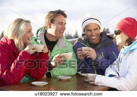 Group Of Friends Enjoying Hot Drink In Café At Ski Resort View Large Photo Image Stock Photo - Group Of Friends Enjoying Hot Drink In Café At Ski Resort. Fotosearch