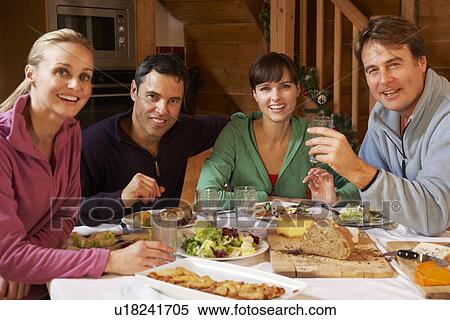 Group Of Friends Enjoying Meal In Alpine Chalet Together View Large Photo Image Stock Photography - Group Of Friends Enjoying Meal In Alpine Chalet Together. Fotosearch