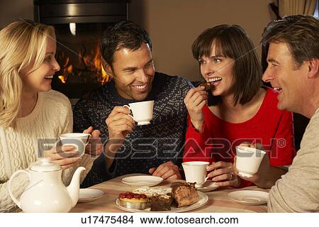 Group Of Middle Aged Couples Enjoying Tea And Cake Together View Large Photo Image Picture - Group Of Middle Aged Couples Enjoying Tea And Cake Together. Fotosearch