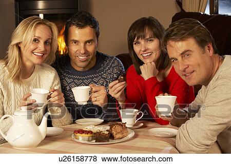 Group Of Middle Aged Couples Enjoying Tea And Cake Together View Large Photo Image Stock Photo - Group Of Middle Aged Couples Enjoying Tea And Cake Together. Fotosearch