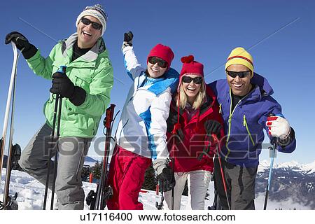 Stock Image - Group Of Middle Aged Couples On Ski Holiday In Mountains. Fotosearch
