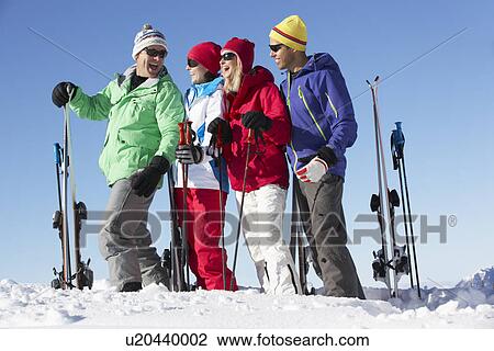 Stock Image - Group Of Middle Aged Couples On Ski Holiday In Mountains. Fotosearch
