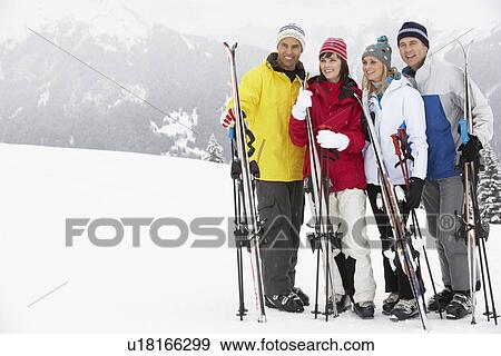 Stock Photo - Group Of Middle Aged Couples On Ski Holiday In Mountains. Fotosearch