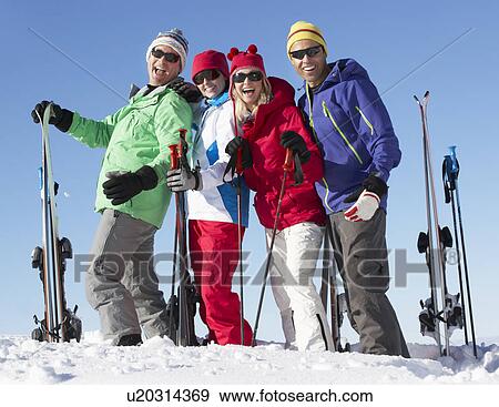Stock Photo - Group Of Middle Aged Couples On Ski Holiday In Mountains. Fotosearch