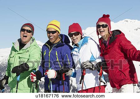 Stock Photograph - Group Of Middle Aged Couples On Ski Holiday In Mountains. Fotosearch