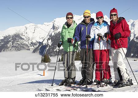Stock Photography - Group Of Middle Aged Couples On Ski Holiday In Mountains. Fotosearch