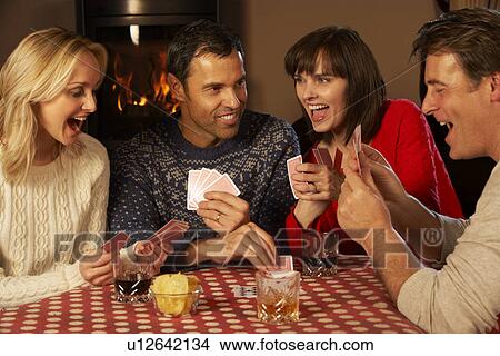 Picture - Group Of Middle Aged Couples Playing Cards Together. Fotosearch