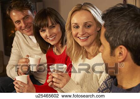 Group Of Middle Aged Couples Sitting On Sofa With Hot Drinks Talking View Large Photo Image Stock Image - Group Of Middle Aged Couples Sitting On Sofa With Hot Drinks Talking. Fotosearch