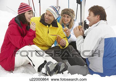 Group Of Middle Aged Friends Eating Sandwich On Ski Holiday In Mountains View Large Photo Image Picture - Group Of Middle Aged Friends Eating Sandwich On Ski Holiday In Mountains. Fotosearch