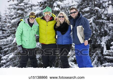Stock Photograph - Group Of Young Friends On Ski Holiday In Mountains. Fotosearch